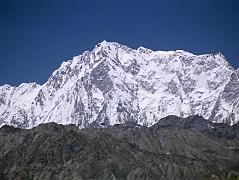 06 Nanga Parbat Rupal Face From The Deosai Plains We drove from Skardu to Tarashing over the Deosai Plains, a high alpine plateau scattered with small tufts of grass and small flowers. We came over a hill and there in front of was the enormous Rupal face of Nanga Parbat, standing alone on the horizon, shining brilliantly white in the sunshine. Starting on the left, the Mazeno Ridge leads to the Rupal Face of Nanga Parbat, and then the summit ridge leads down past the North Peaks to the Southeast Peak and East Peaks and then plummets to Rakhiot Peak.